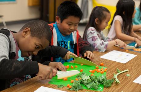 Kids chopping veggies