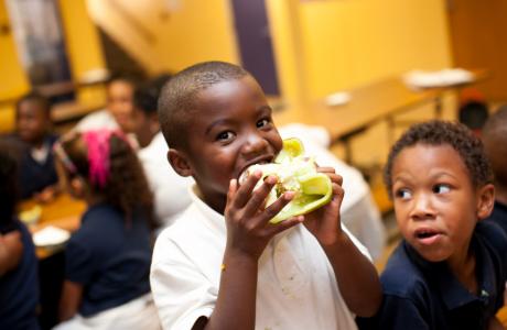 Student eating a bell pepper