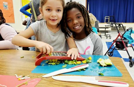 Kids cutting veggies