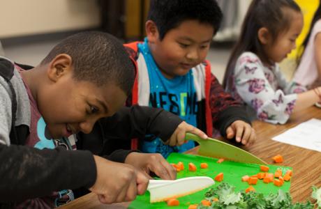 Kids cutting veggies