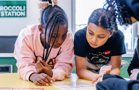 From left: Elementary students Lyric and Maeva, both age 10, review a food label during a cooking class on Feb. 4, 2026 at Food Literacy Center in Sacramento. (Photo by Andri Tambunan)