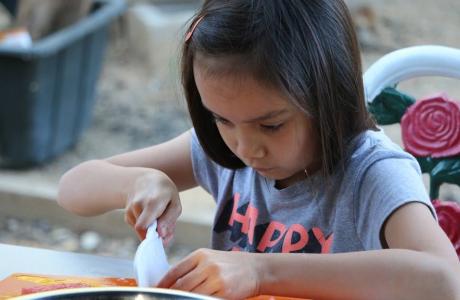 Girl chopping basil