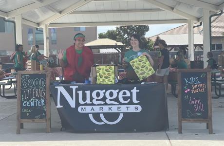 Staff behind market table