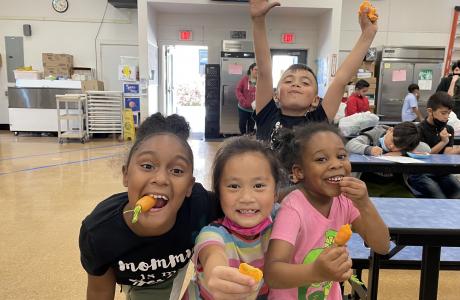 Kids eating carrots