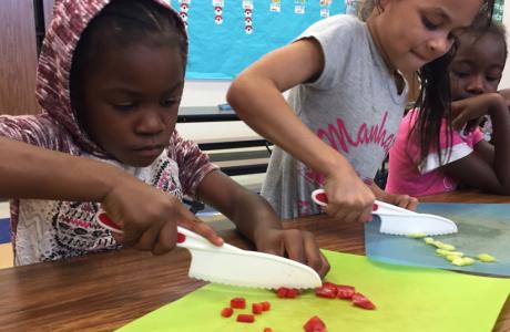 students chopping veggies