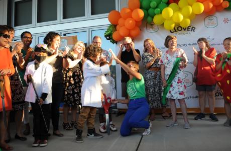 Amber Stott cutting ribbon with students and dignitaries