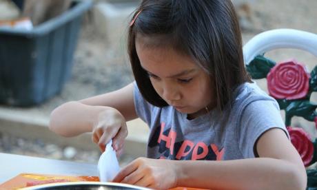 Girl chopping basil