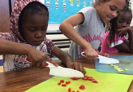 students chopping veggies