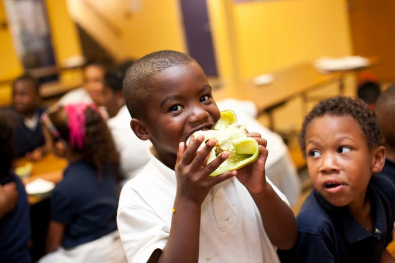 Student eating a bell pepper