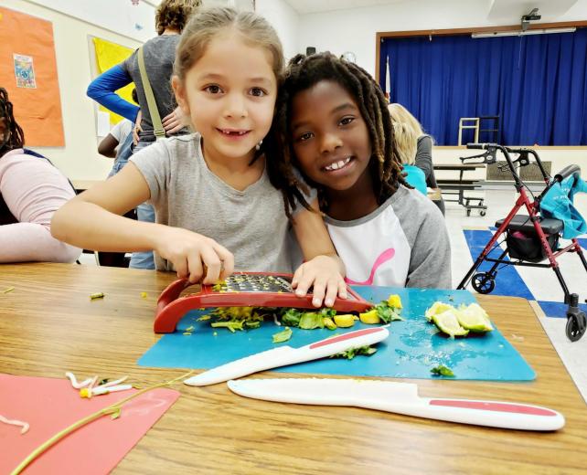 Kids cutting veggies