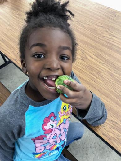 Girl eating brussel sprouts