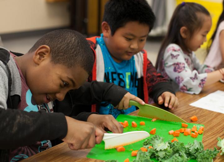 Kids cutting veggies