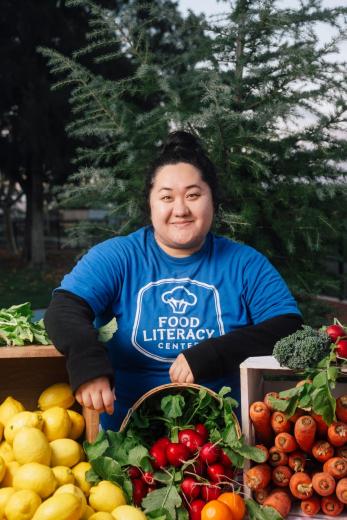 Headshot of Cindy behind produce stand
