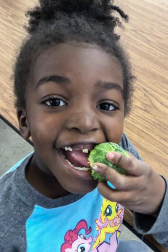 kid eating brussel sprout