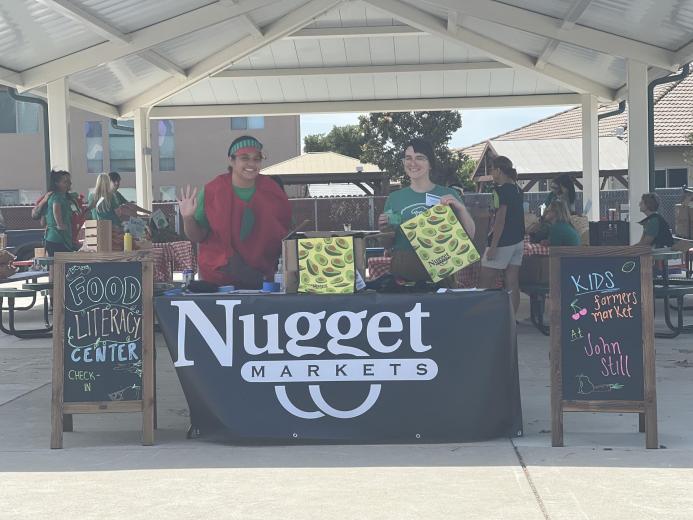 Staff behind market table