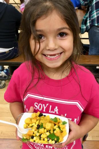 Kid smiling with recipe