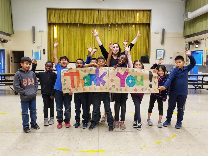 Group of kids holding thank you sign